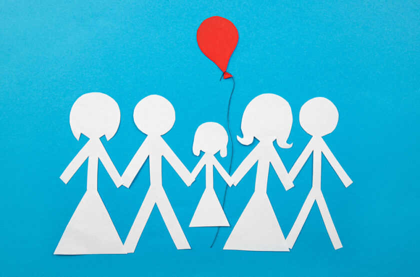 Paper cut out of two sets of parents and a child