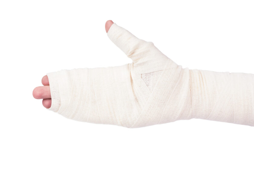 Damaged bandaged the man's hand on a white background