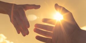 Hand reaching out to another