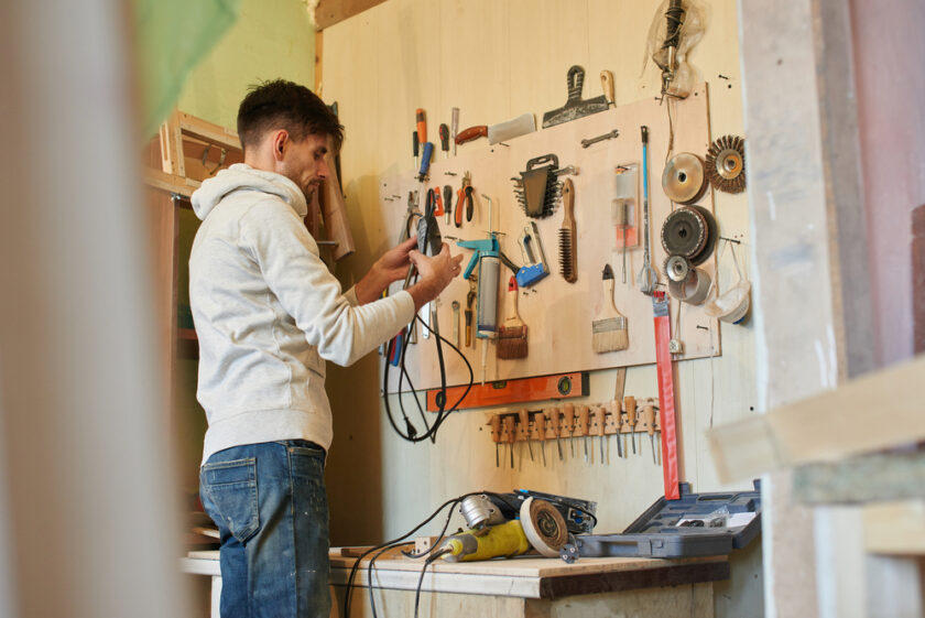 Portrait of a guy working in a home workshop