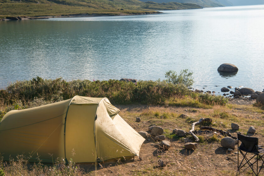 Tent set up next to a lake