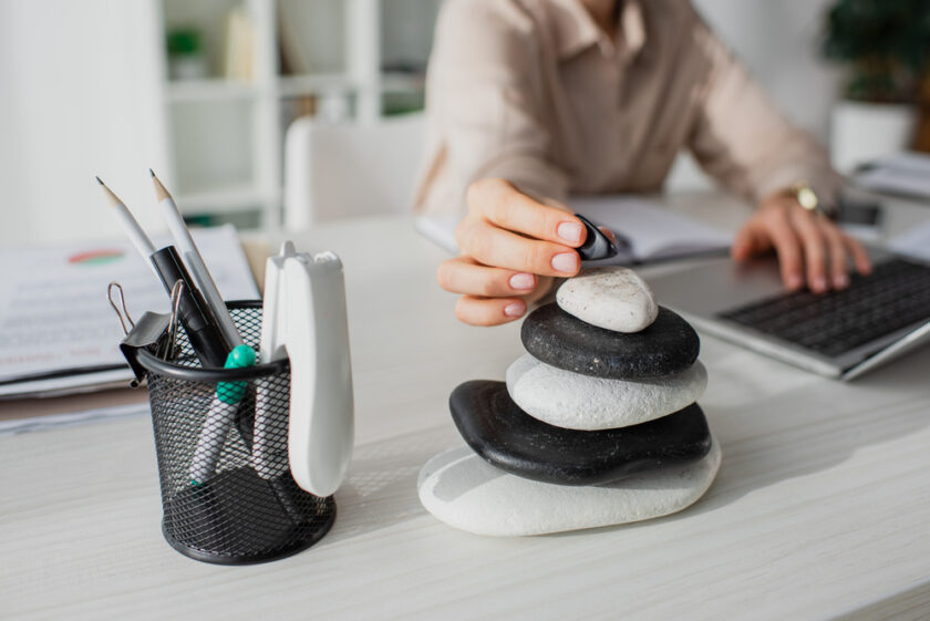 Woman stacking stones at her desk