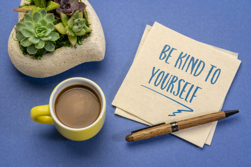 be kind to yourself - inspirational handwriting on a napkin with a cup of coffee, self care concept