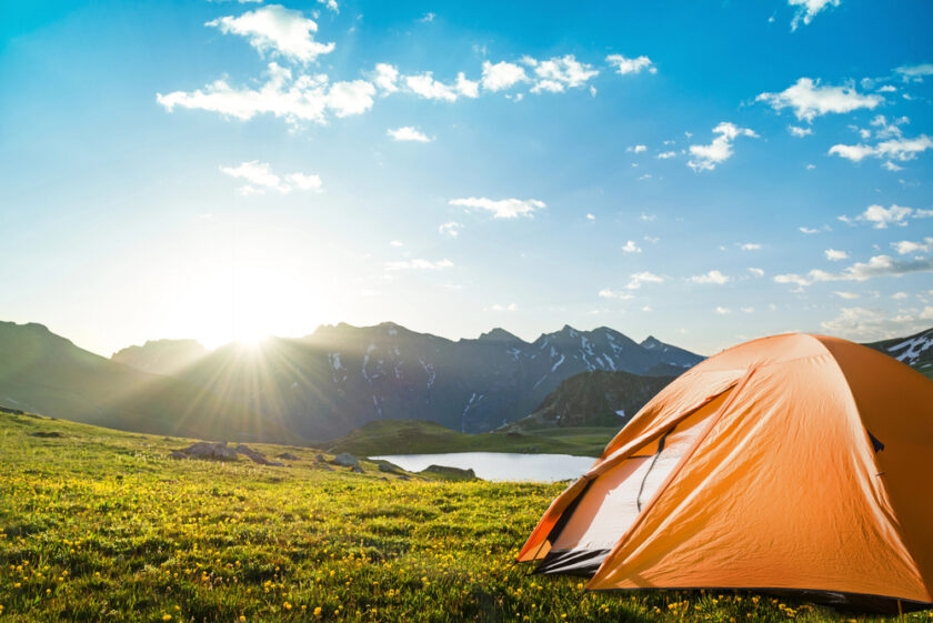 Orange tent near a lake 