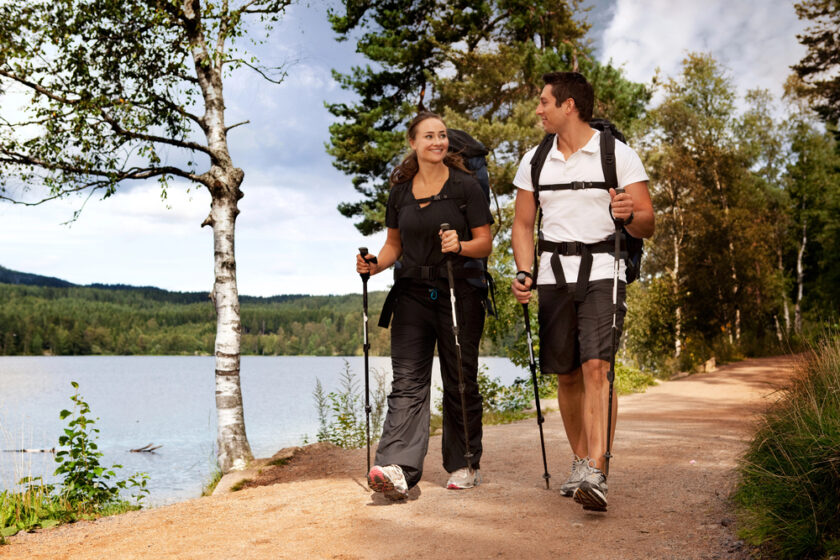 People hiking beside a lake