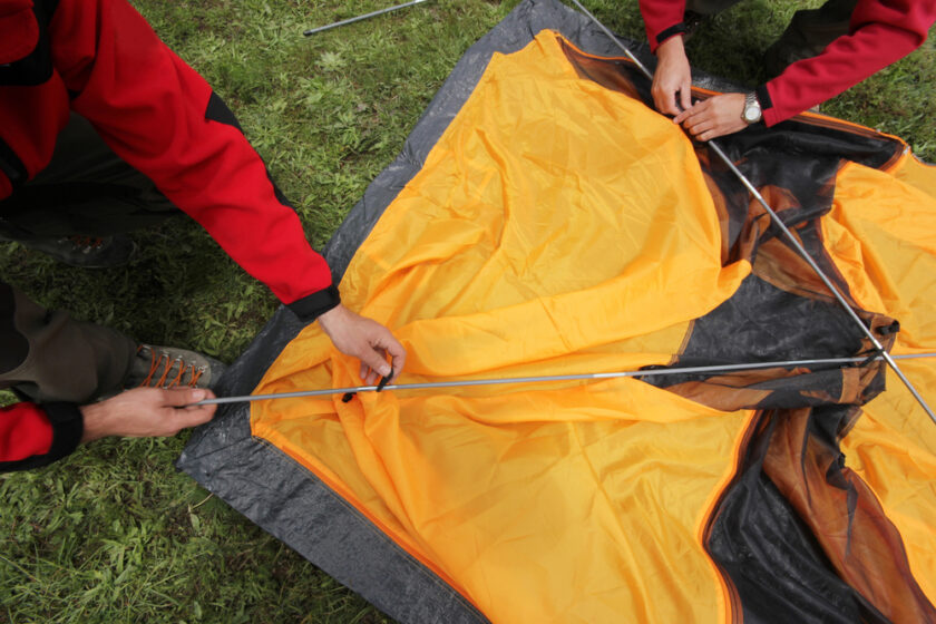 People trying to put up a tent