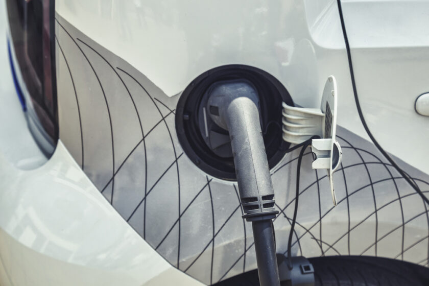 Electric car charging connect to electric car. Power cable pump plug in charging power to electric vehicle EV car with modern technology.