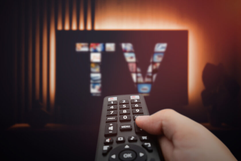 Smart TV, watching television, remote control in hand