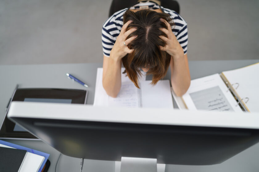 High Angle Shot of a Stressed Office Woman Working on the Documents on her Table, Scratching her Head