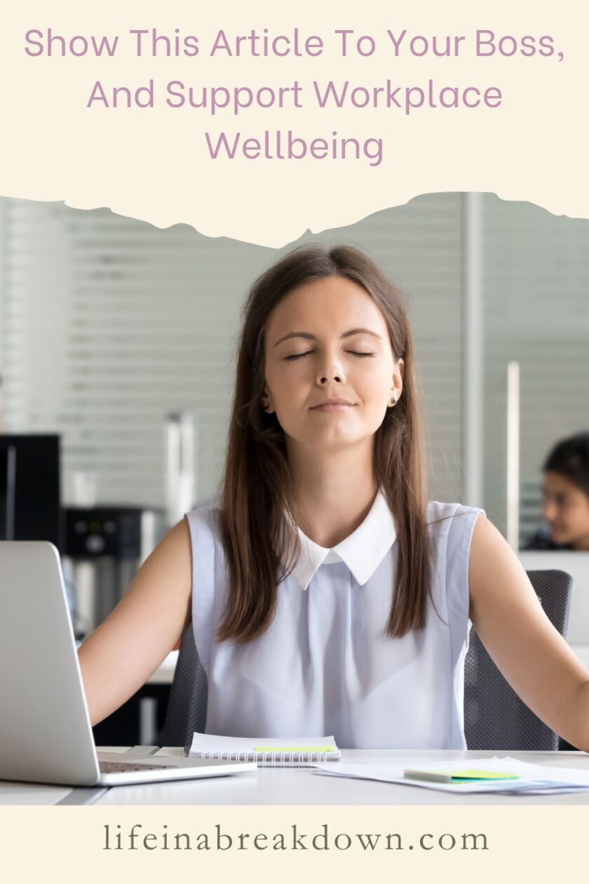 A woman sitting at a desk with closed eyes, appearing relaxed. She is in an office setting with a laptop and notebook in front of her. Text above reads, Show This Article To Your Boss, And Support Workplace Wellbeing. Website URL at the bottom.