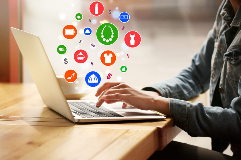 Woman using laptop for browsing internet store at table, closeup. Online shopping concept