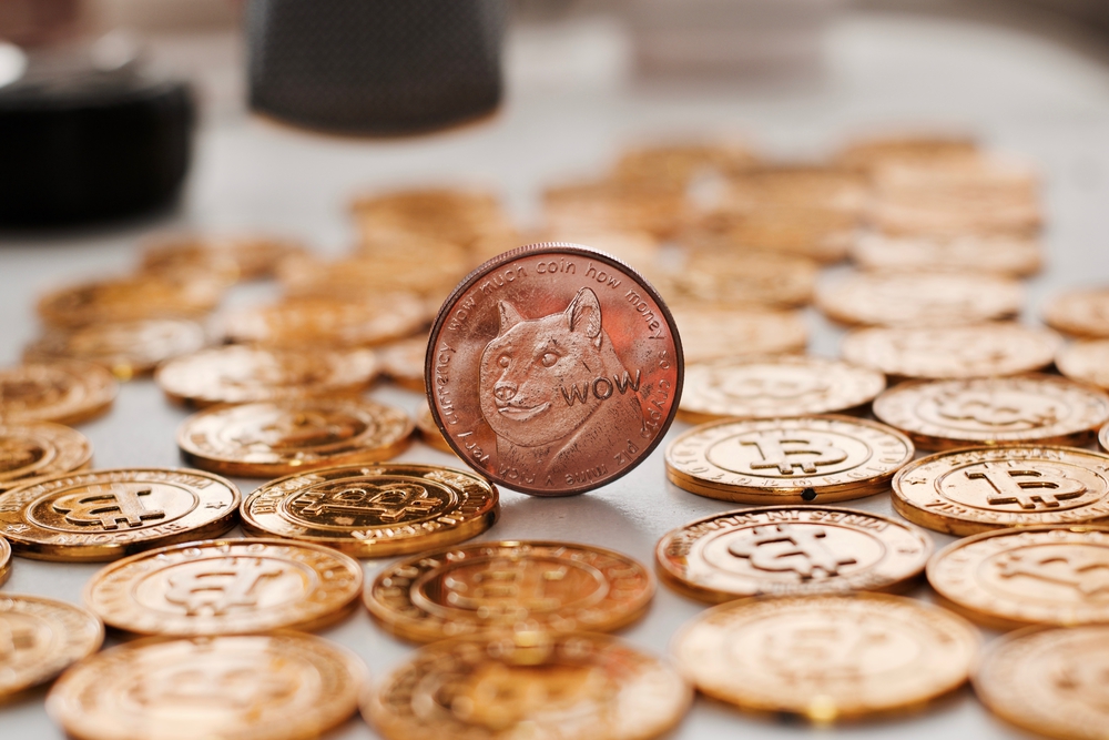 Digital currency physical metal dogecoin coin on the gold bitcoins. Gold money concept.