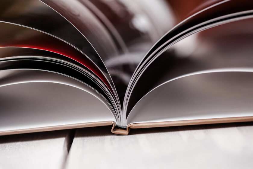 Photo book from the side with pages open,
