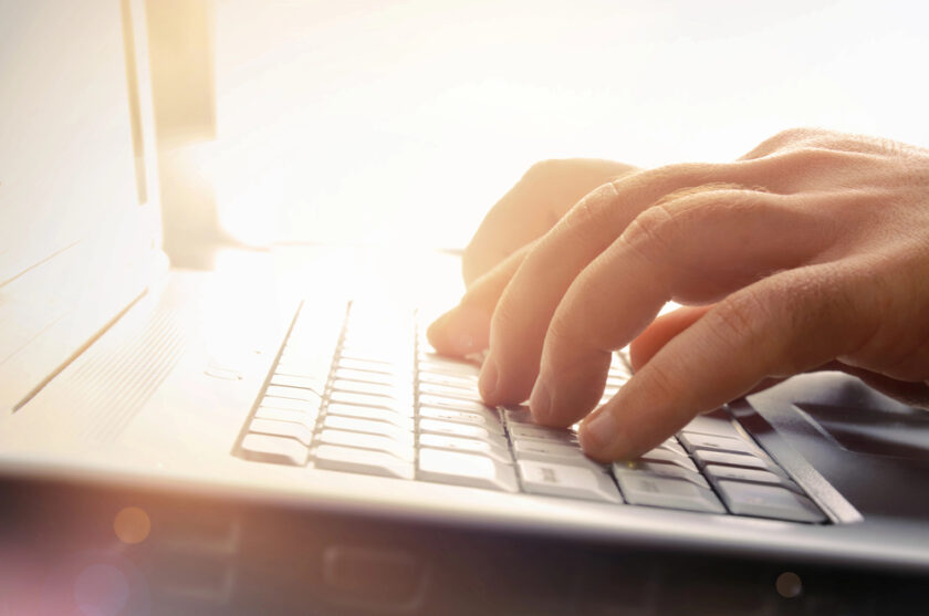 mans hands on a laptop