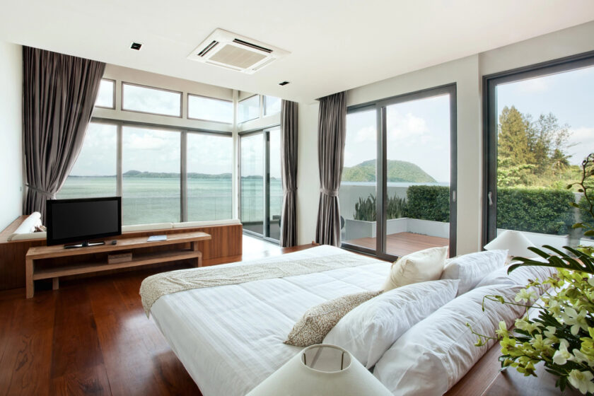 Tranquil looking bedroom with large windows looking over an incredible view