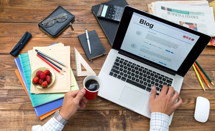 Person working on a laptop writing a blog
