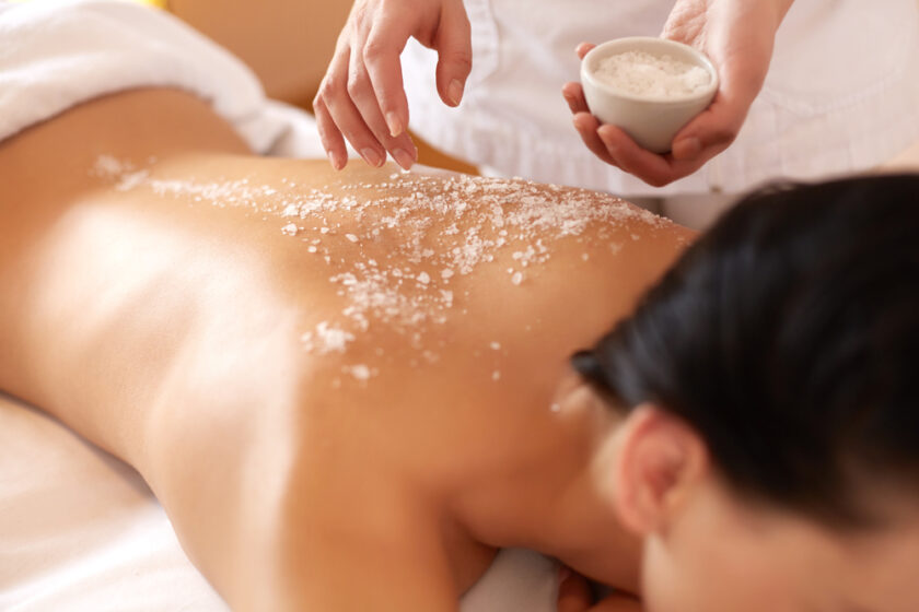 Spa Woman. Brunette Getting a Salt Scrub Beauty Treatment in the Health Spa. Body Scrub.