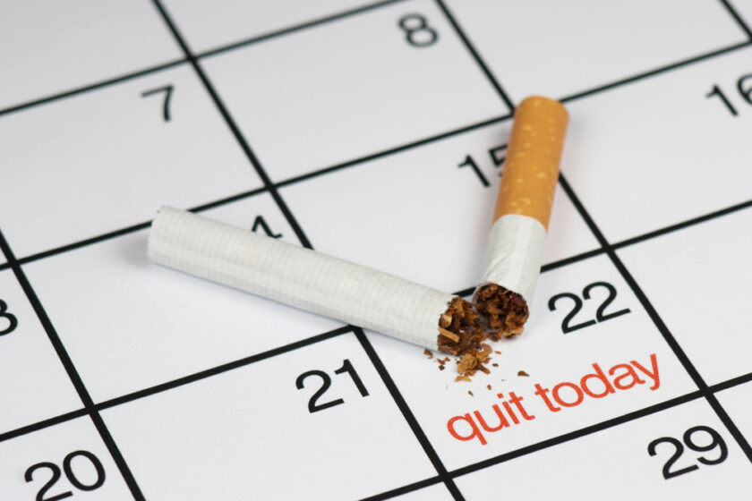 Broken cigarette on a calendar marked as quit today