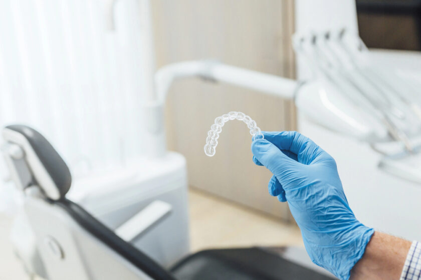 Dentist holding an aligner