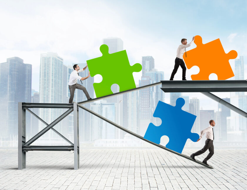 People pushing puzzle pieces as a metaphor for setting up business