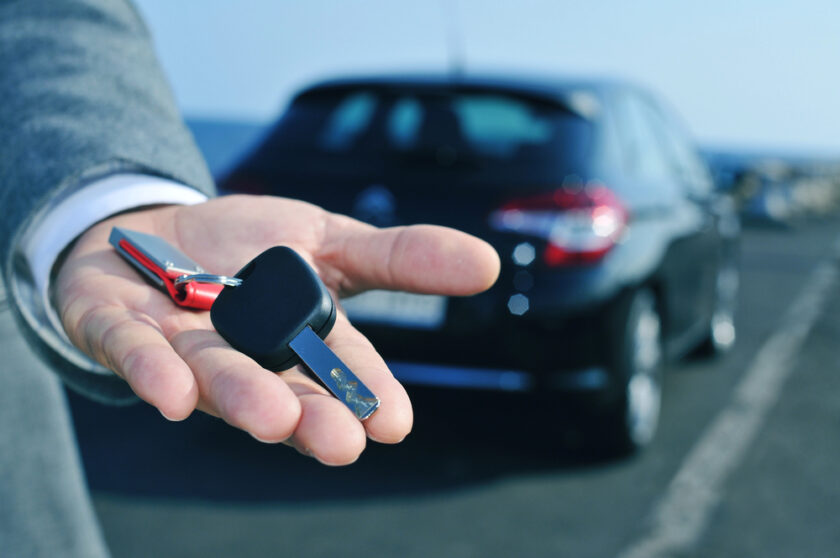 car sales person with a key