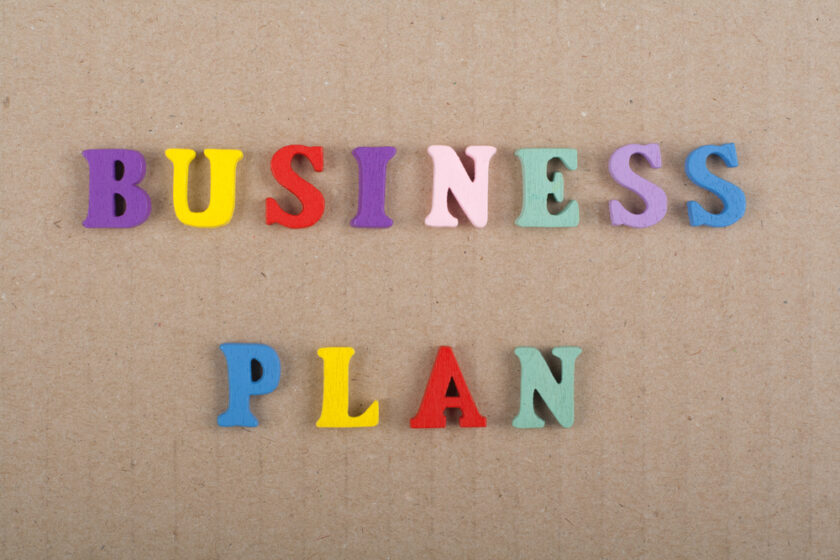 word on wooden background composed from colorful abc alphabet block wooden letters spelling out business plan
