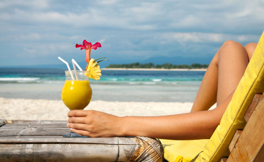 Person with a cocktail on a the beach