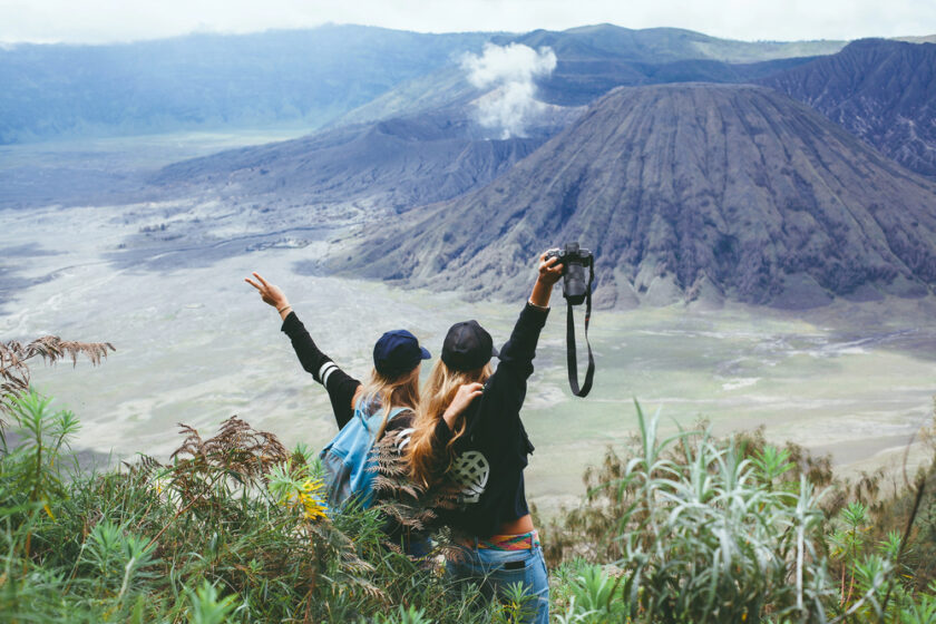 Two people backpacking in front of an incredible view