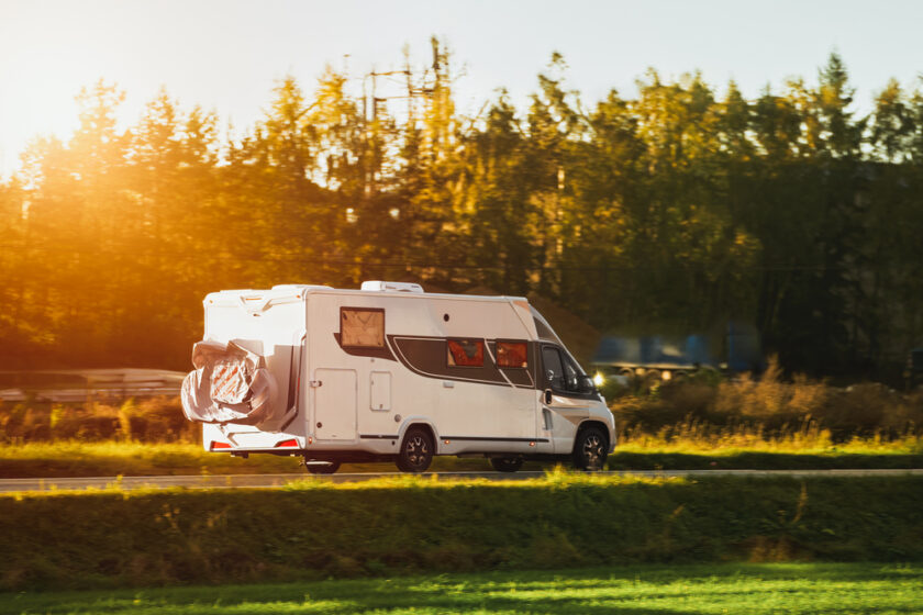 RV motorhome camper van on the highway with bike rack. Travel vacation adventure. Tourists in rental campervan. Tourism in motorhome