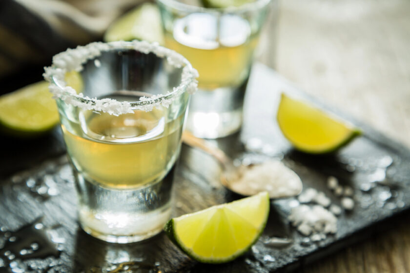 Tequila sat out in glasses with a lemon to the side