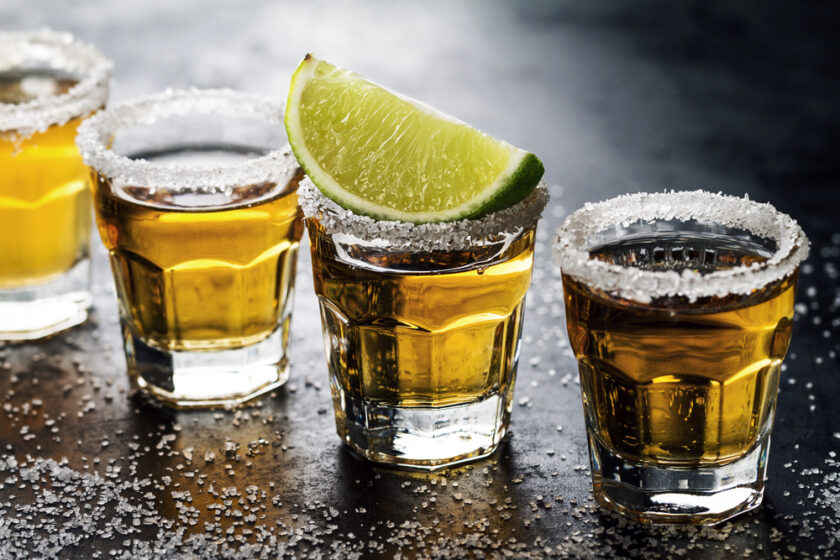 Tequila sat out in glasses with a lime on top