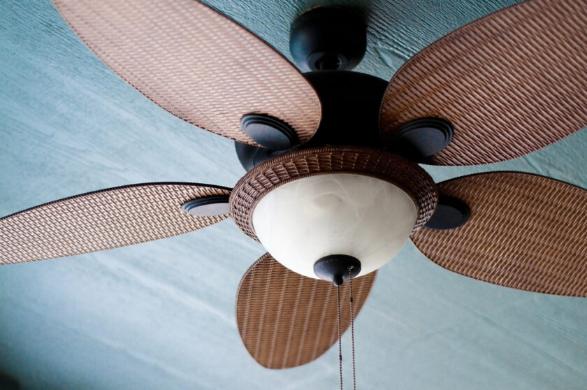 Close up of a ceiling fan with brown blades