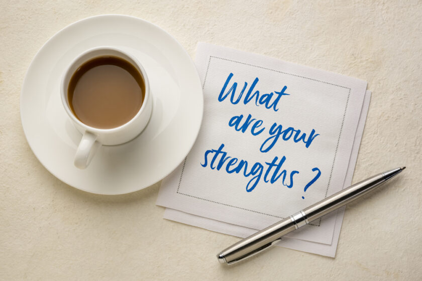 what are your strengths question - handwriting on a napkin with a cup of coffee