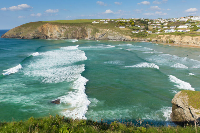 Beautiful surfing beach near Newquay of Mawgan Porth north Cornwall England uk on a summer day with blue sky on the Cornish Atlantic coast