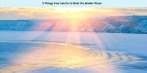 Sunset over a snowy landscape with a frozen body of water reflecting sunlight. The sky is partly cloudy. The text at the top reads, 5 Things You Can Do to Beat the Winter Blues.