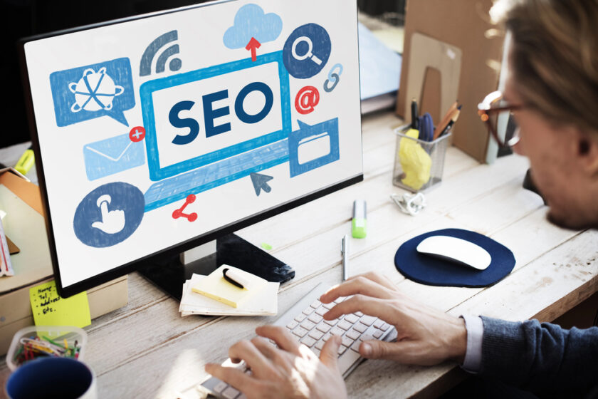 Someone working on a computer with SEO on the screen