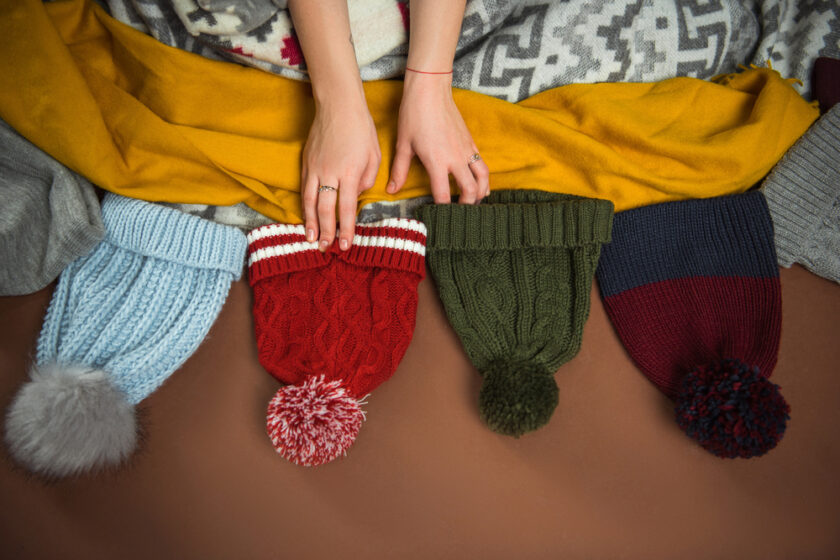 woman choosing a hat to wear