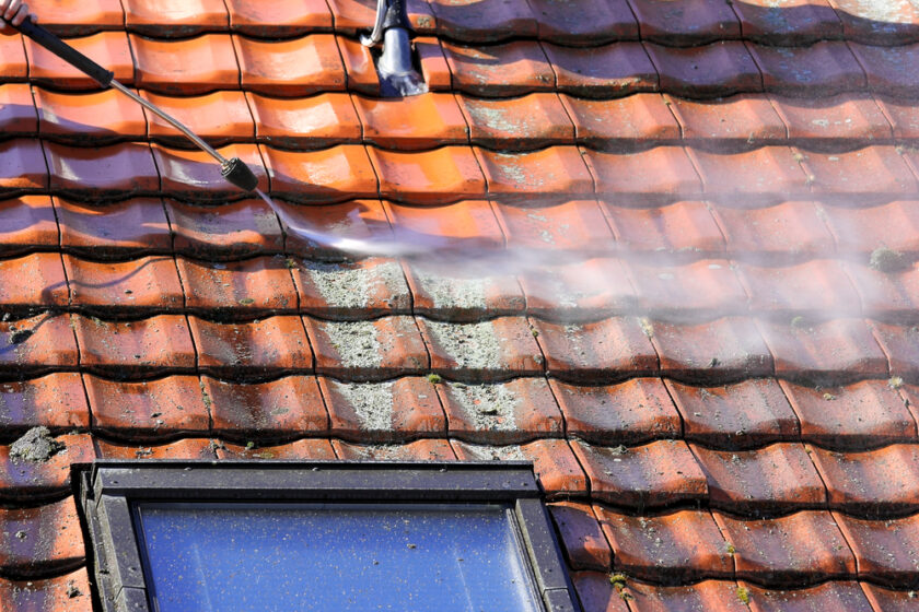 Roof being cleaned with a pressure washer