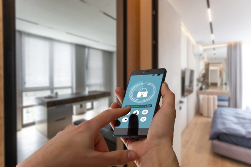 Person holding a phone with a smart home app on it
