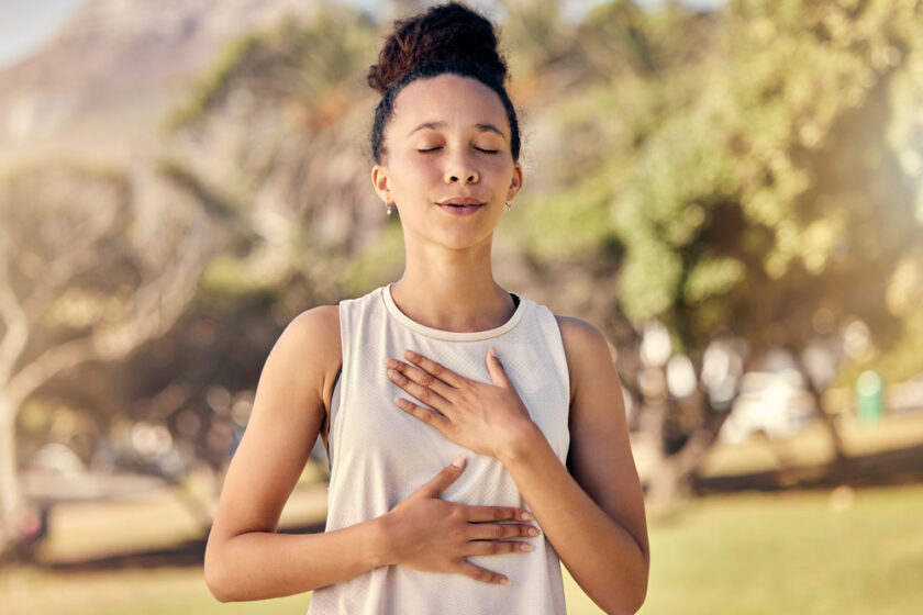 Fitness, woman and yoga breathing in relax for spiritual wellness, mental wellbeing or calm exercise in nature. Female relaxing, exercising and training in warm up breath activity for healthy workout.