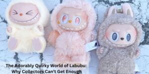 Three plush Labubu dolls in pastel yellow, pink, and brown with big eyes and toothy grins are displayed on a cracked white surface. Text reads, “The Adorably Quirky World of Labubu: Why Collectors Can’t Get Enough.”.