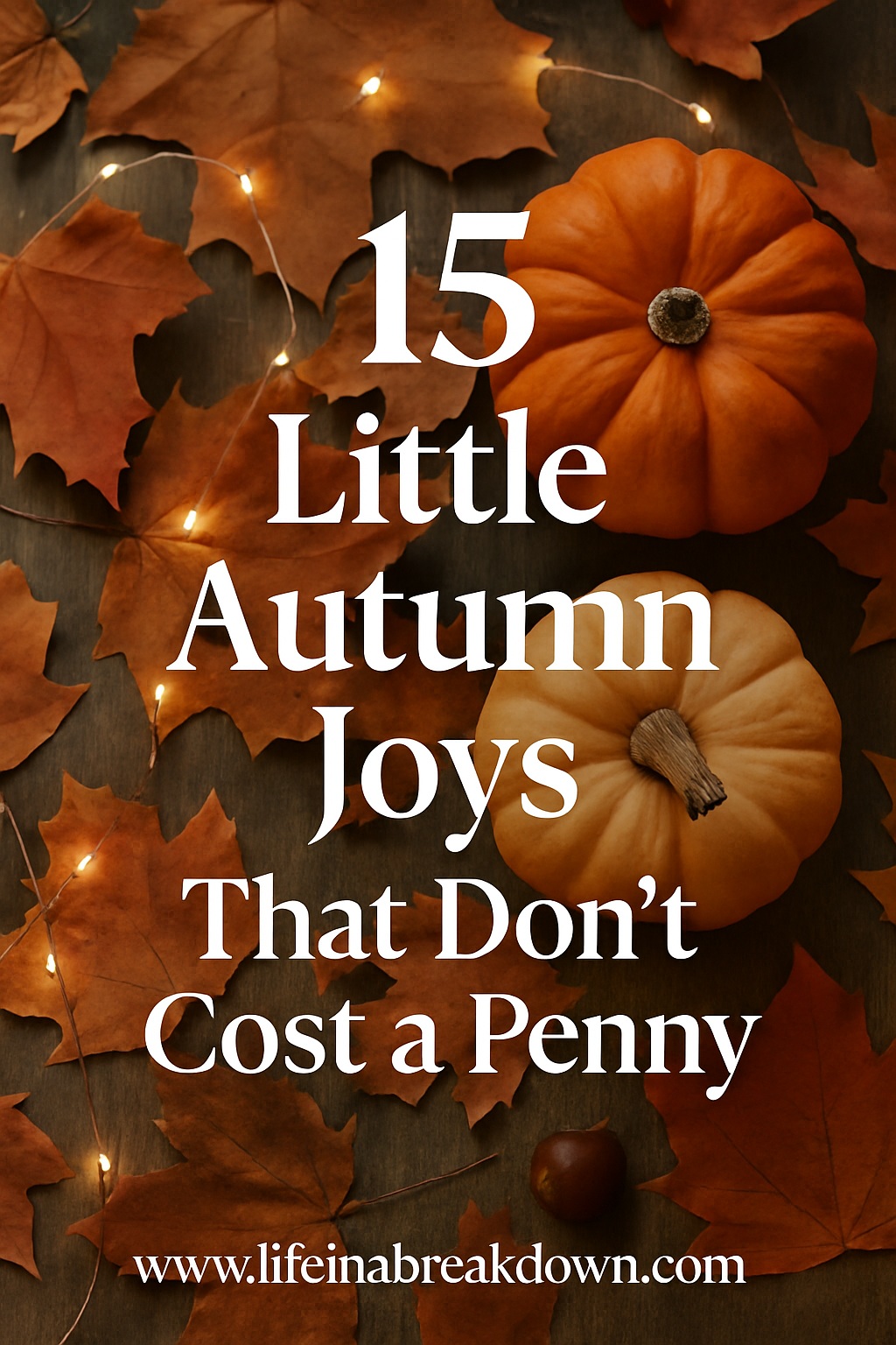 Two small pumpkins and scattered autumn leaves on a wooden surface with fairy lights. Text reads: 15 Little Autumn Joys That Don’t Cost a Penny. www.lifeinabreakdown.com.