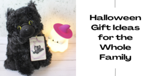 A fluffy black cat soft toy sits next to a white ghost-shaped nightlight with a pink witch's hat. Text on the right reads: Halloween Gift Ideas for the Whole Family.