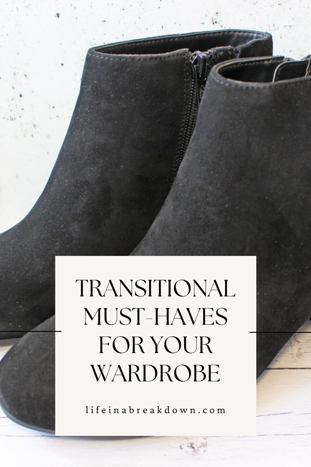 A pair of black suede ankle boots is displayed behind a white box with the text Transitional Must-Haves For Your Wardrobe lifeinabreakdown.com.