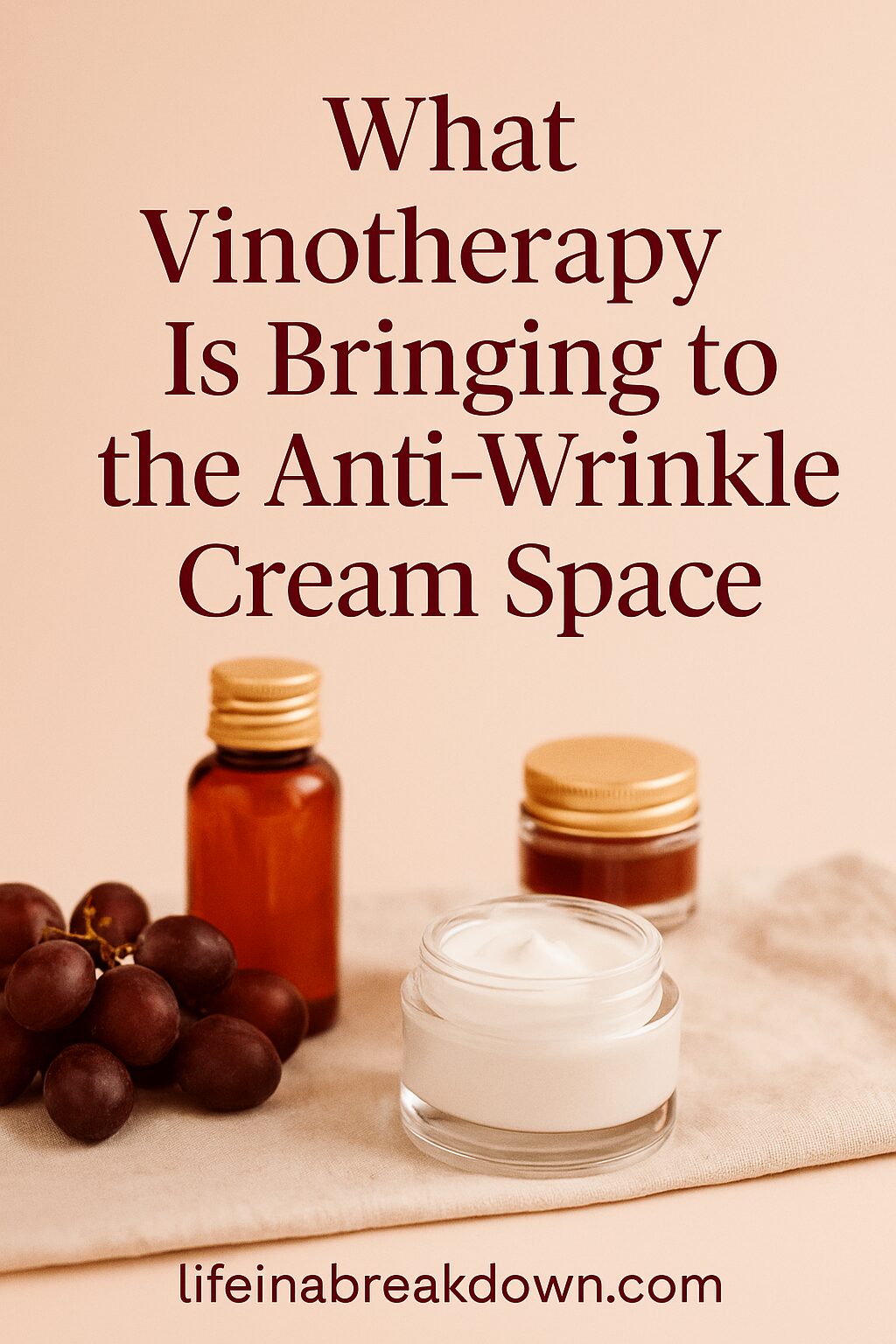 A jar of white cream, two brown bottles, and a bunch of grapes are arranged on a beige surface with the text, What Vinotherapy Is Bringing to the Anti-Wrinkle Cream Space above them. Website: lifeinabreakdown.com.