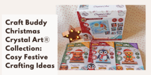 A Craft Buddy Christmas Crystal Art Collection set is displayed with three festive crystal art cards featuring a penguin, a reindeer, and a gingerbread man, plus a lit wooden star decoration beside the kits. Text promotes cosy festive crafting ideas.