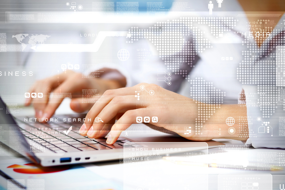 Hands typing on a laptop keyboard with digital interface icons, graphs, and a world map overlay, representing technology, global communication, and data concepts.