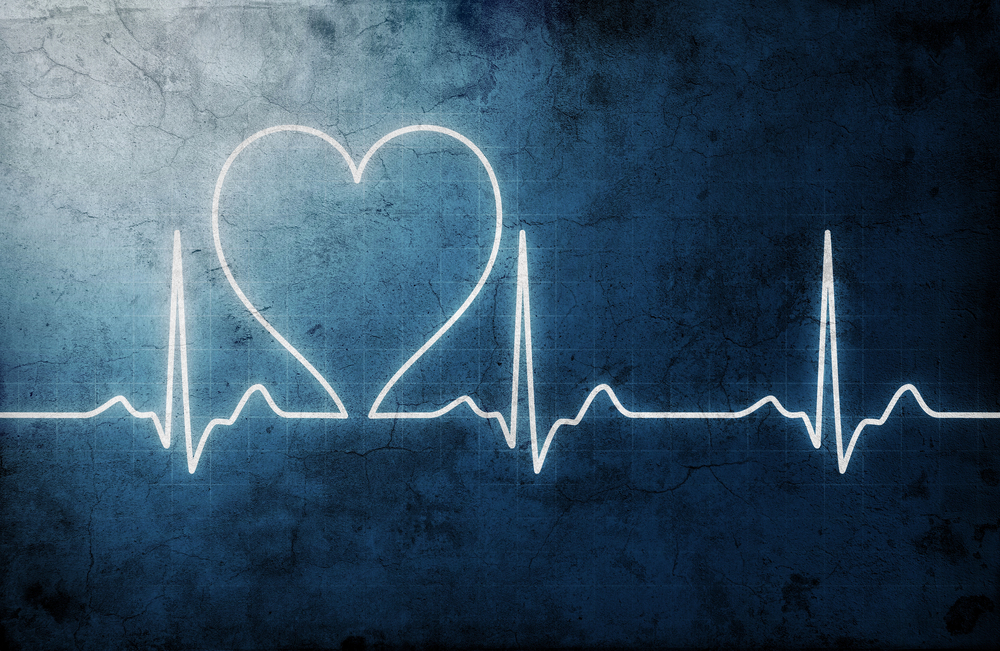 A blue, textured background with a white electrocardiogram (ECG) line forming the outline of a heart shape in the centre, blending medical and love themes.