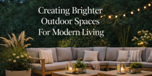 A cosy outdoor patio with a large grey sectional sofa, throw pillows, lanterns with candles, greenery, and string lights overhead. Text reads, Creating Brighter Outdoor Spaces For Modern Living.