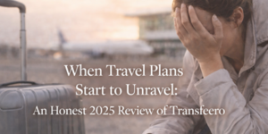 A person sits beside a suitcase at an airport, covering their face with their hand in frustration. The text reads, When Travel Plans Start to Unravel: An Honest 2025 Review of Transfeero.